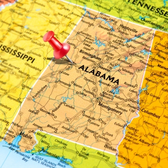 Map of Mississippi and Alabama with push pin in Alabama