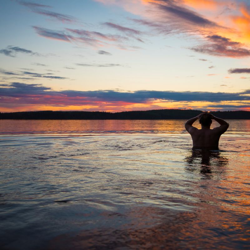 man taking a dip after sauna in the Baltic sea