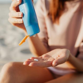 Image of a person applying sunscreen.