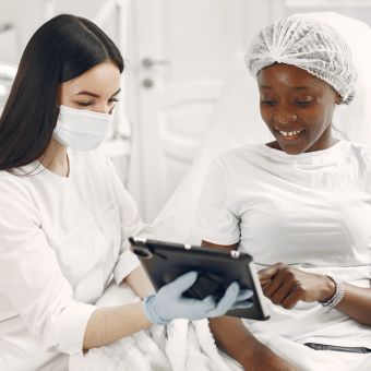 Image of two people looking at a tablet.