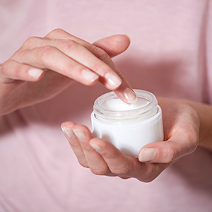 Image of a person using a lotion.