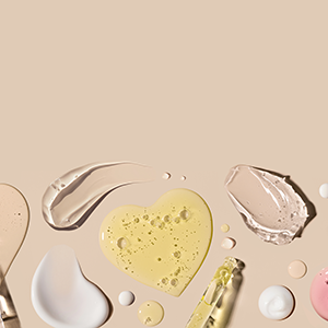 samples of cosmetic care products smear of cream texture on a beige background.