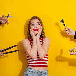 woman surrounded by beauty tools with hands, expressing fashion concepts, yellow background