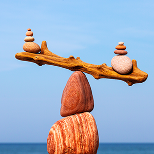 Balanced Rock Zen on the background of the sea. The concept of fall risk and unstable equilibrium.