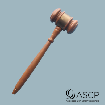 Brown gavel over blue-grey background with ASCP logo