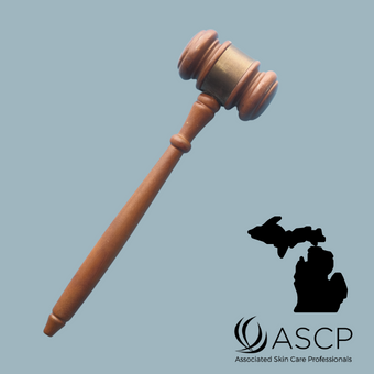 Brown gavel on pale blue background.