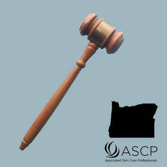 Brown gavel over blue grey background with shape of Oregon