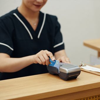 Skin care professional swiping credit card