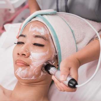 Woman receiving radio frequency service from an esthetician
