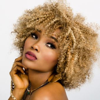 Woman with blonde coily hair