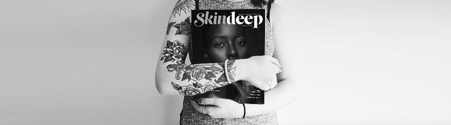 Woman with tattoos on her arm holding ASCP Skin Deep magazine