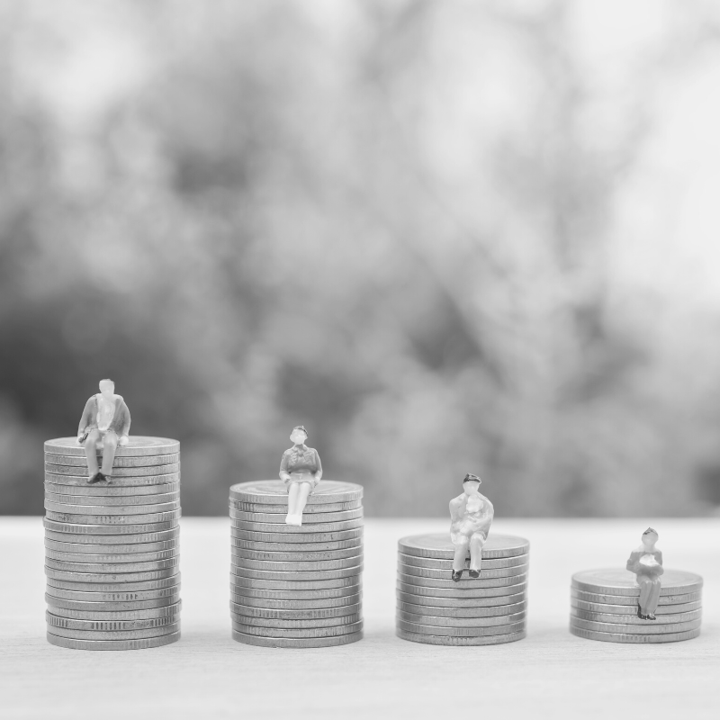 People sitting on stacks of coins