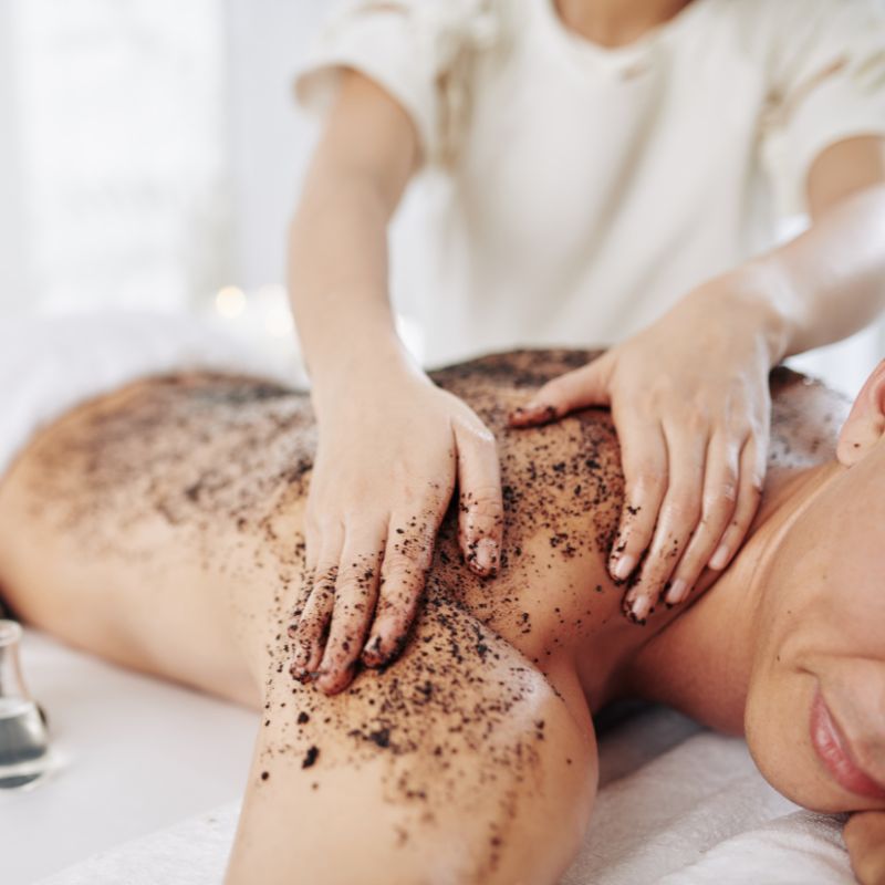 A client getting a massage with caffeinated ingredients.