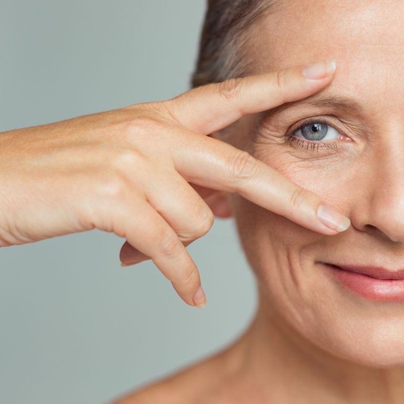 woman holding her fingers to her eyes