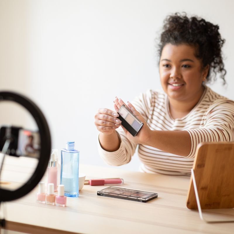 Image of a person recording themselves using makeup.