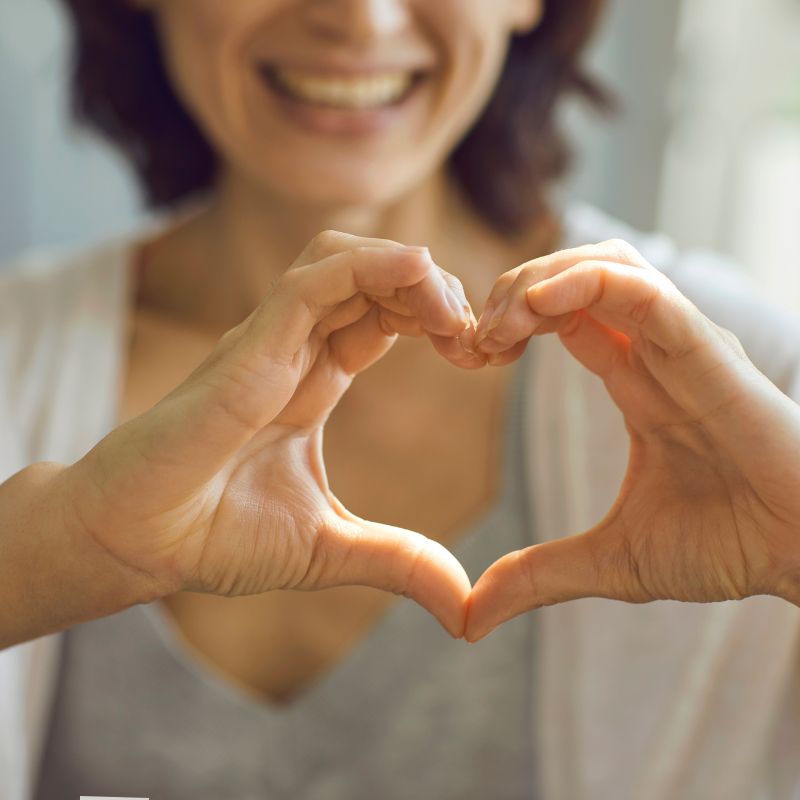 Image of a person holding their hands in a heart shape.