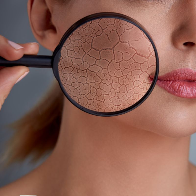 image of a person holding a magnifying glass to their face.