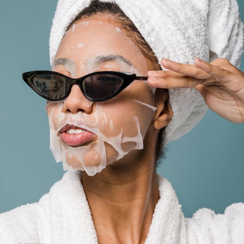 image of a person with a spa mask on wearing sunglasses.