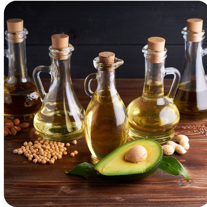 Image of an avocado surrounded by jared oils.