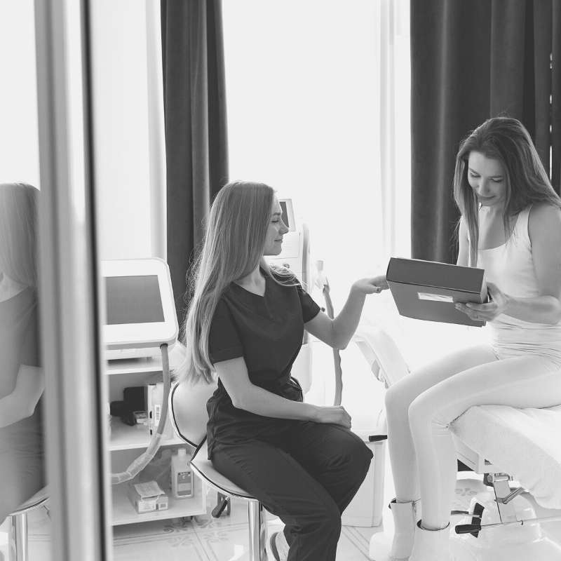 woman consults with client in the treatment room