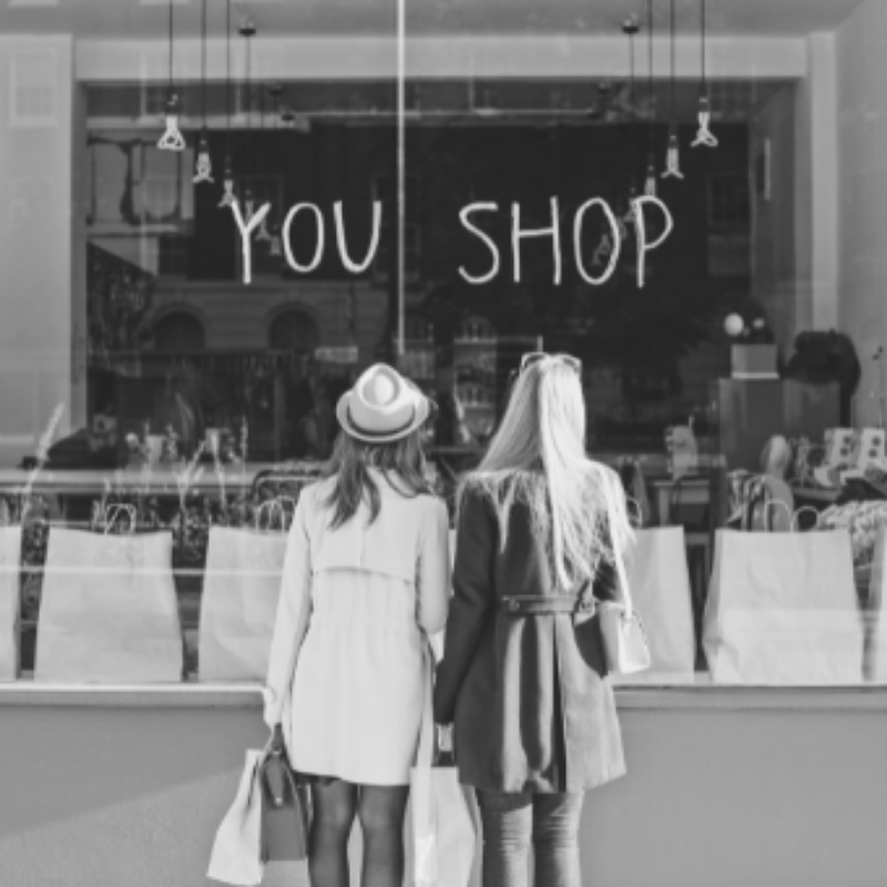 two girls standing outside a retail store