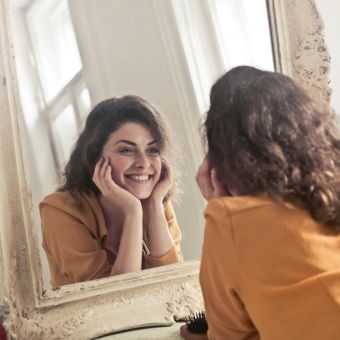 Image of a person looking in the mirror.