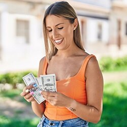 Scholarships Article Image - Woman counting Benjamins