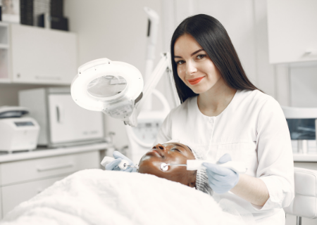 Smiling esthetician with her client