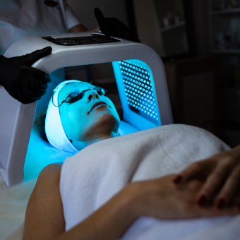 Women receives LED light therapy to face