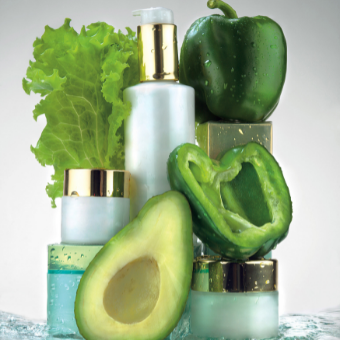 skin care products surrounded by green vegetables