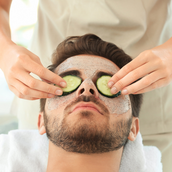 Man with cucumbers on his eyes
