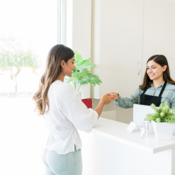 Esthetician greets her client at the front desk