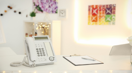 Front desk with phone and pretty pictures on the wall