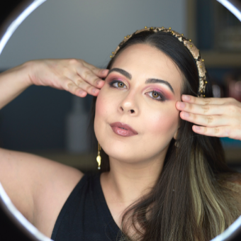 Woman vlogger poses in front of ring light