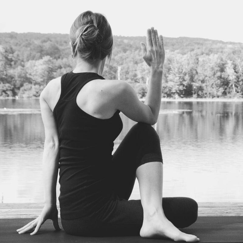 Girl doing yoga by the lake